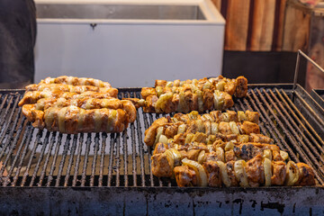 A few sticks of kebab in a grilled street stall.