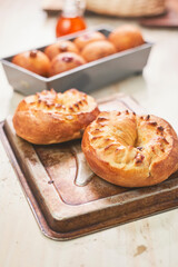 A beautifully golden-brown Rosca or roscón bread sits on a rustic baking tray, its crust perfectly crisp and glistening with a warm glow.