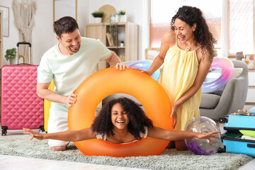 Happy family with inflatable ring at home. Travel concept