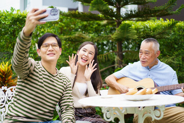 Happy multi-generation Asian family living together in weekend