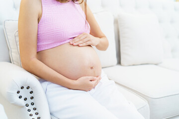 Asian pregnant woman relaxing at home.