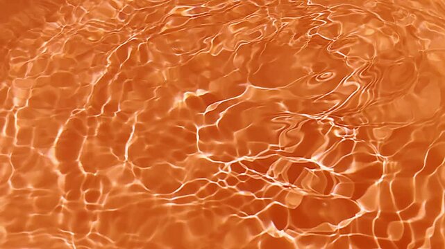 Abstract orange background. Pink water bubbles on the surface ripple. Blurred transparent pink colored clear calm water surface texture with splash and bubbles. Water waves with shining pattern.
