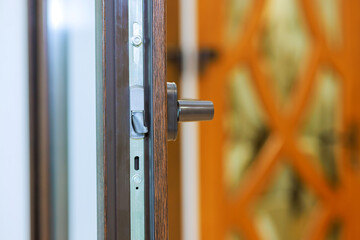 Door handle highlighting its sleek design functionality beautiful features an ornate pattern, enhancing aesthetic appeal in contemporary setting.