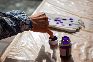 Inonesian voter dipping hand to purple electoral ink at 2024 mayoral and governorship election, the...