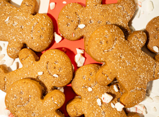Group of gingerbread men laying in crushed peppermint all around