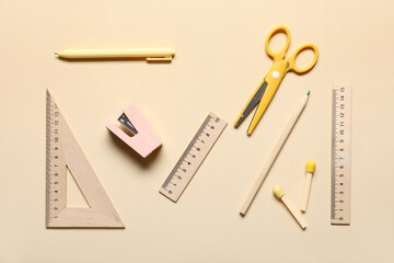 Set of different stationery with wooden rulers on color background