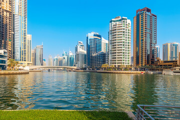 Fototapeta premium The Dubai Marina, a waterfront promenade of shops, boat marinas and skyscrapers, along the coast of Dubai, United Arab Emirates. 