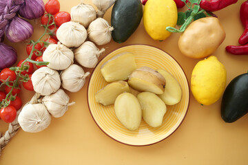 A Beautiful Arrangement of Fresh Vegetables and Fruits Displayed on a Bright Yellow Background