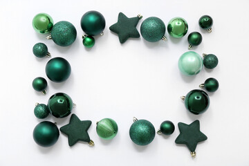 Frame made of different Christmas balls on white background