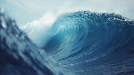 Giant waves curl majestically near the shore, creating an ideal scene for surfers in a serene beach setting during twilight