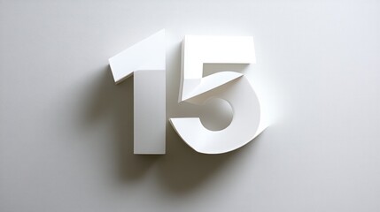 A stylized representation of the number 15 in white paper against a light background.