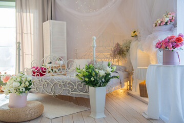 This charming bedroom showcases stunning floral arrangements, vintagestyle furniture, and gentle, soft lighting