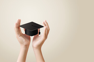A pair of hands holding a graduation cap symbolizing education and success
