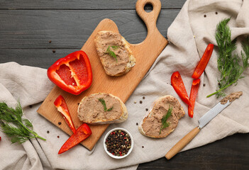 Board with toasts, tasty pate, chili and bell peppers on dark wooden background