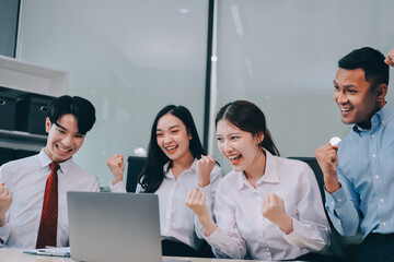 Group of Young Asian business team creative businesspeople coworker in office Happy to be successful partnership teamwork celebrating achievement and success concept.