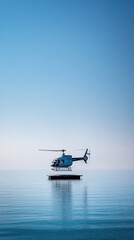 A helicopter on a platform in calm waters under a clear blue sky.