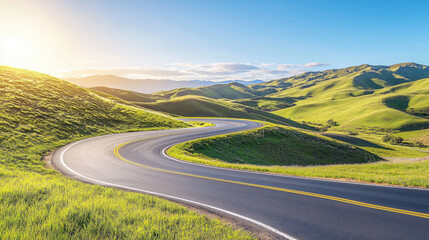 Curving road through lush green hills under clear blue sky