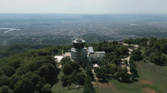 Cable car station on dajti mountain overlooking tirana on a clear sunny day, aerial view