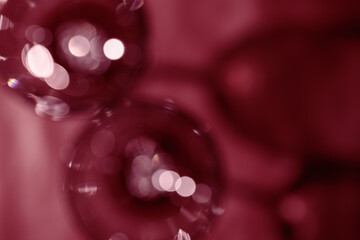 Wine glasses defocused, red wine color blurred background with light flare, optical blur, bokeh....