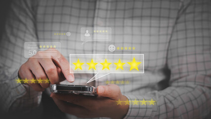 Business man using smartphone and giving five (5) stars satisfaction review survey in online...
