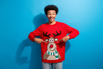 Photo portrait of pretty young male point deer excited wear red christmas sweater masquerade theme party on blue color background