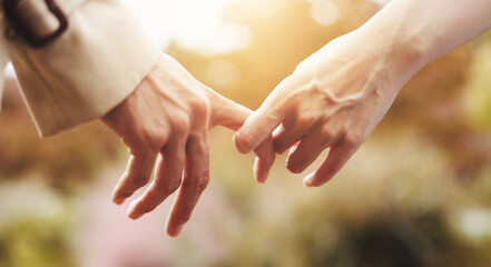 Love, closeup and holding hands with couple in park for romance, bonding and relationship. Support, care and trust with people in Japan nature date for connection, commitment and peace together
