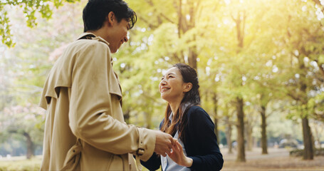 Smile, dance and holding hands with Japanese couple in park for romance, bonding and relationship. Support, care and happiness with man and woman in Japan nature for date, commitment and peace