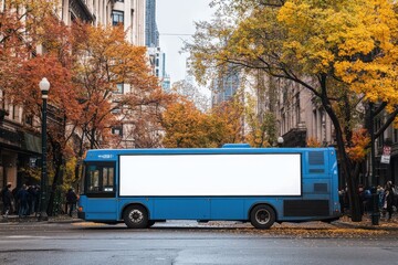 Obraz premium A blue bus parked on a city street with a blank white advertisement space on its side