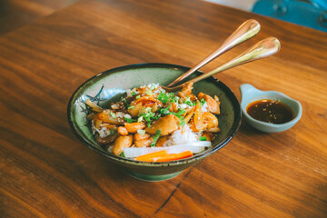 A very tasty teriyaki chicken rice bowl with sauce poured over rice.