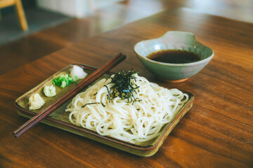 A famous Japanese cold noodle dish served with sauce and side dishes.