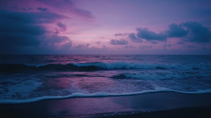 Obraz premium Tranquil Twilight Beach, a serene shoreline bathed in deep purples and blues, gentle waves caressing the sand, evoking a sense of calm and peacefulness at dusk.