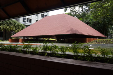 Semi-outdoor building with aesthetic red triangular roof