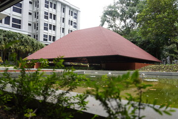 Semi-outdoor building with aesthetic red triangular roof