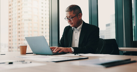 Office building, Japanese businessman and laptop with typing, documents or project management as...