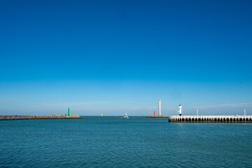 A calm waterfront scene with a serene sea and clear blue sky creates a perfect atmosphere for relaxation