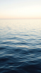 Obraz premium Gentle ripples disturb the otherwise glassy surface of the sea , gentle, ripples
