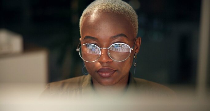 Black woman, glasses and computer in office for news, business research and reflection at night. Economy journalist, tech or reading in agency for article resource, proofreading or stock market study