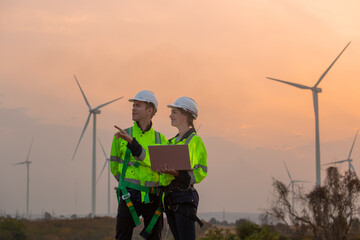 Team engineer wearing safety uniform holding laptop discussed plan about renewable energy at...