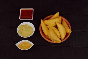 Delicious traditional Colombian empanadas with spicy sauce