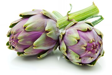 Two artichokes with vibrant purple hues and green leaves, showcasing natural produce.