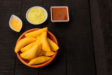 Colombian empanada with spicy sauce (
