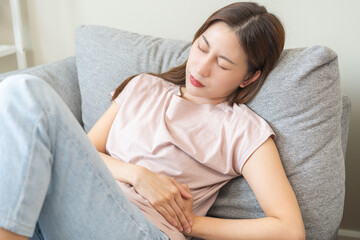 Flatulence asian young woman intolerance hand in stomach ache, suffer from food poisoning,...