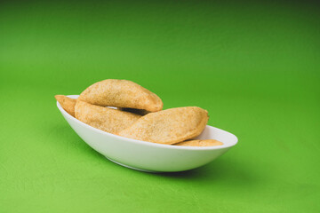 Delicious traditional Colombian empanadas with spicy sauce