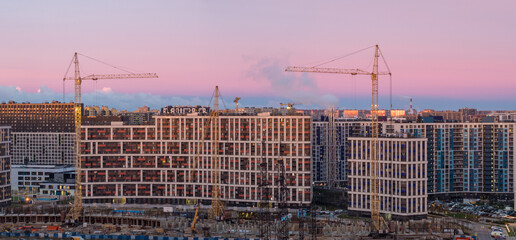 construction site and cranes at dawn