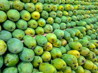 background with piles of mangoes on display and for sale