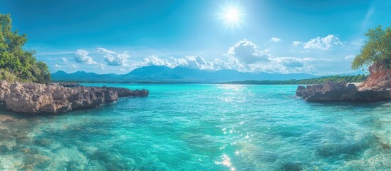 Naklejka premium Panoramic tropical beach view featuring emerald waters, stone breakwater, and vibrant sunlight ideal for beach erosion strategy concepts.