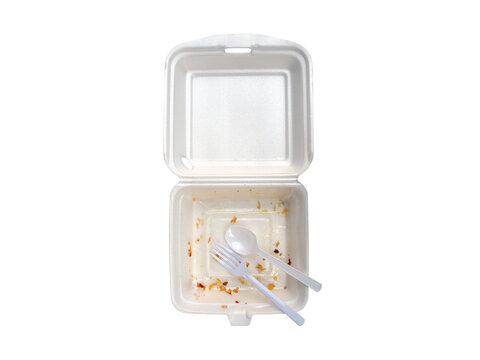 food scraps in opened foam box with plastic spoon and fork isolated on transparent