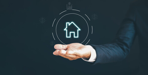 Real estate investment concept, interest rates and business growth planning. Businessman holding house icon in hand.