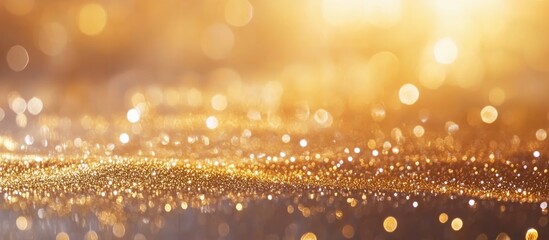 Golden bokeh background of sparkling lights creating a festive atmosphere ideal for Christmas and holiday themed designs and decorations