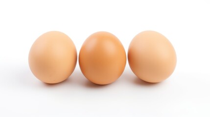 Three brown eggs arranged in a row on a clean white background showcasing simplicity and freshness in food photography